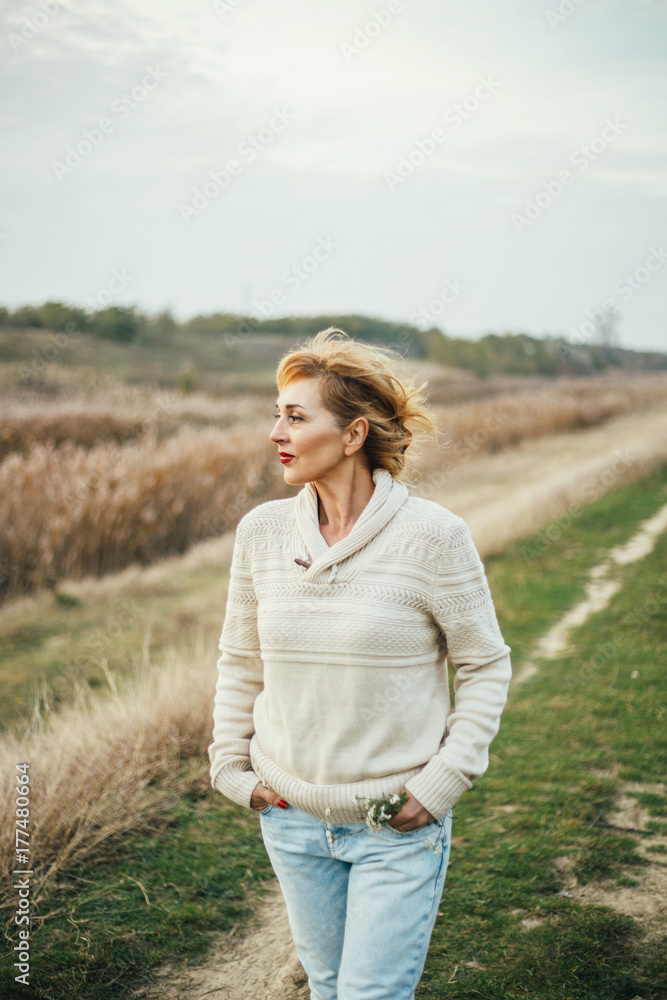 Beautiful middle aged woman walking outside Beautiful middle aged woman walking outside