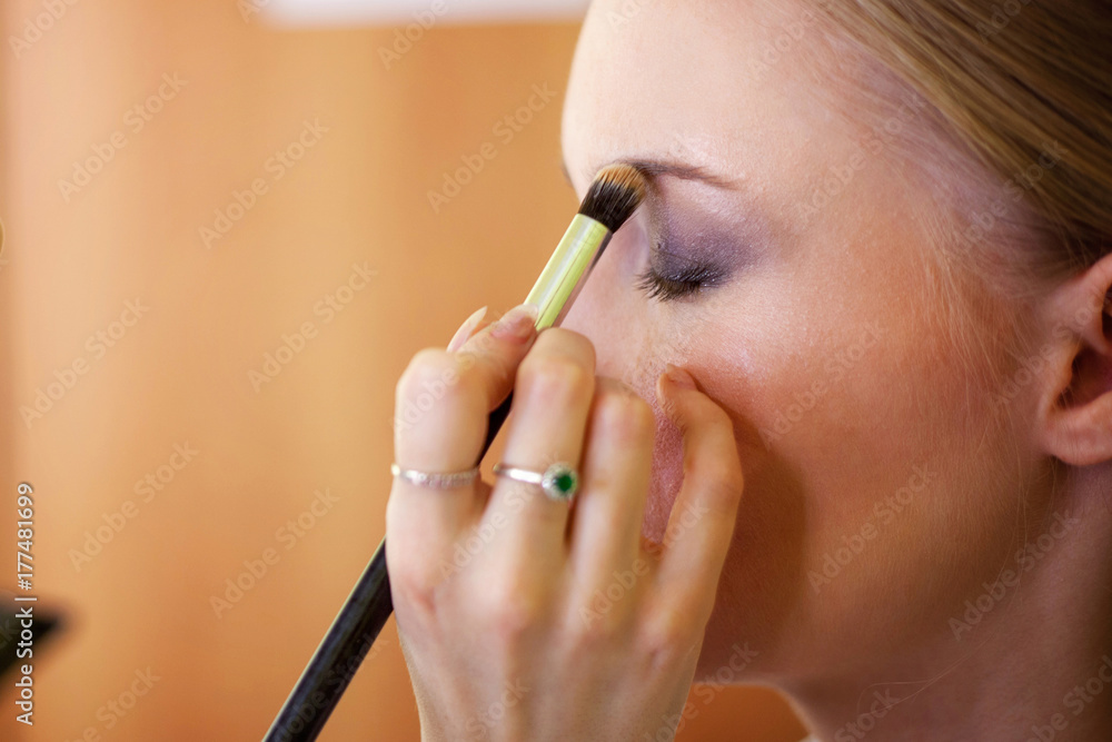 makeup artist paints eyes