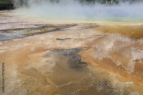 sulphur pool with cloud reflections and steam rising in Yellowstone National Park in Wyoming