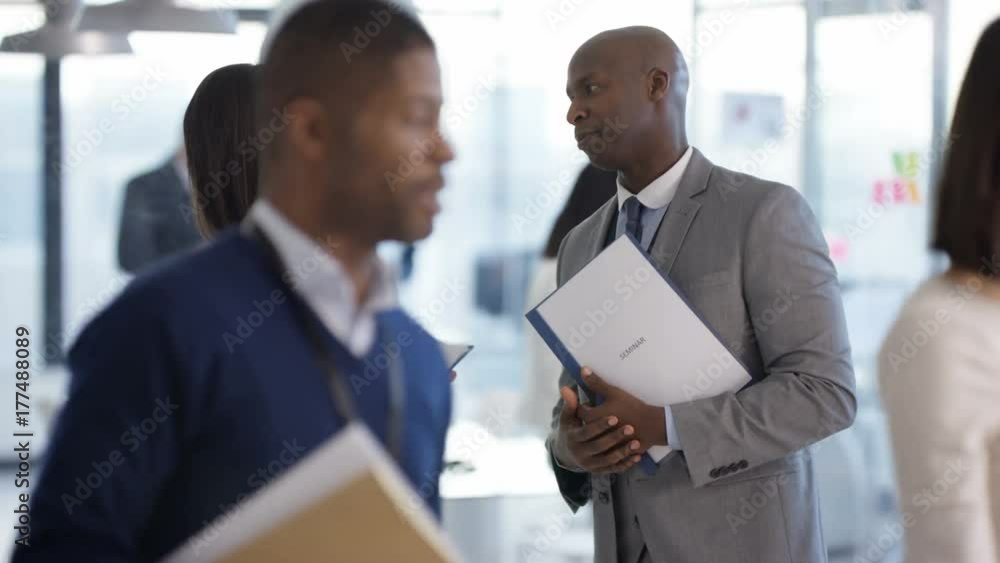 Business people at a conference meeting, chatting & meeting other delegates. Business people at a conference meeting, chatting & meeting other delegates.
