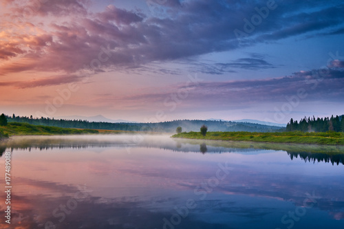 Morning mist rises over the Snake River at Oxbow Bend, Grand Teton National Park, Wyoming