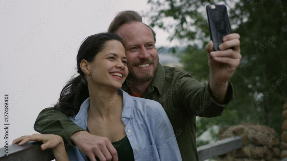 Happy couple on African vacation posing for selfie at Victoria Falls Happy couple on African vacation posing for selfie at Victoria Falls