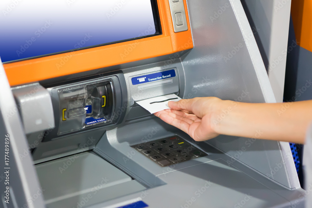 Hand inserting ATM card into bank machine for withdraw money Hand inserting ATM card into bank machine for withdraw money