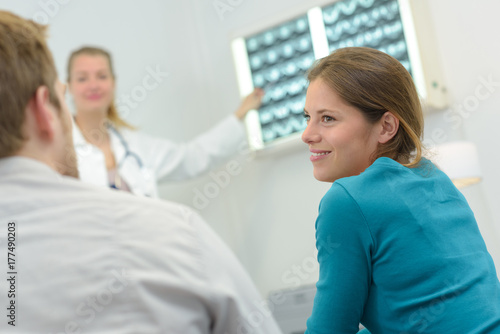 woman doctor reading mri film scans to patient