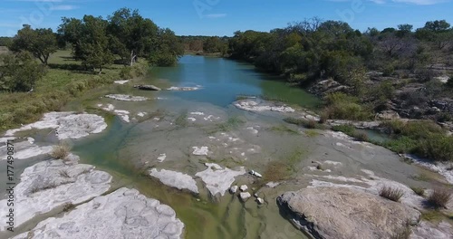 A daytime aerial flyover establishing shot of a creek in Oklahoma.	 photo