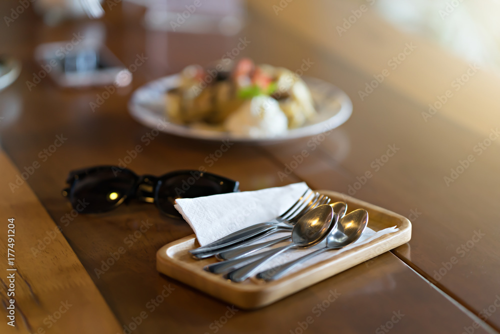 silver fork and spoon on table with wooden tray silver fork and spoon on table with wooden tray