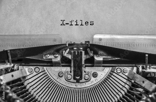 X-files, classified materials are printed on an old vintage typewriter. Close-up.