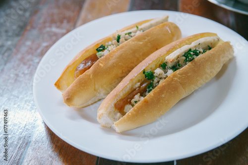 Vietnam Bread stuffed with Chinese sausage and pork on white plate.