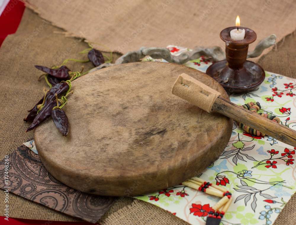Various djembes and tambourine in front of a rustic wall. Various djembes and tambourine in front of a rustic wall.