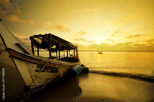 Fishing boat in sunset photo