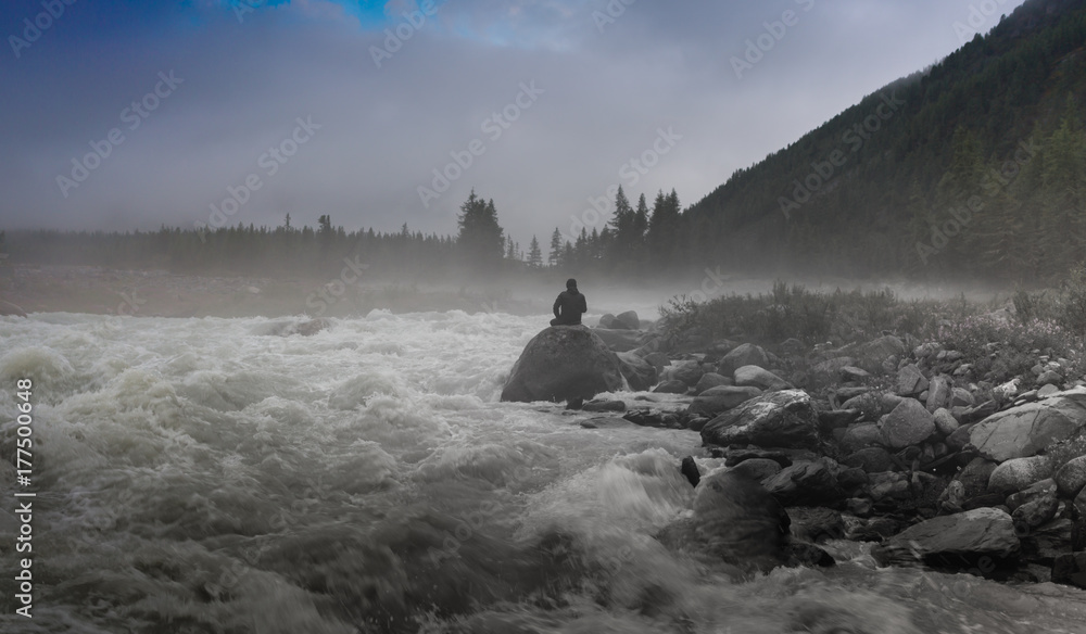 Silhouette of a man in the darkness. Night Photography. Dense fog over the river. Silhouette of a man in the darkness. Night Photography. Dense fog over the river.