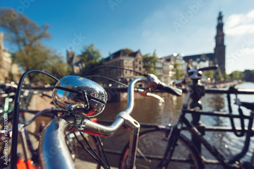 Photography Shiny bicycle bell on the background of Amsterdam city at sunny day