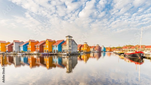 Colorful houses reflected in the water in Groningen in the Netherlands