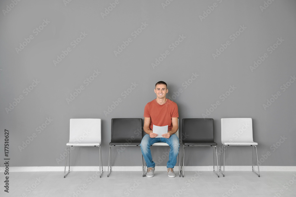 Fototapeta premium Young man waiting for job interview in hall