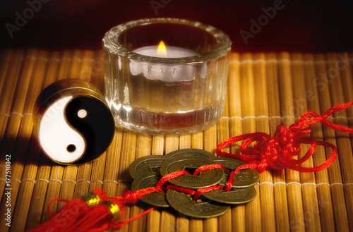 Yin yang  oriental chinese lucky coins  a candle like a concept for china astrology and chinese esoteric topics and oriental belief 