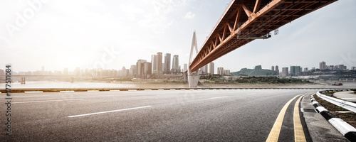 empty asphalt road with modern bridge and buildings photo