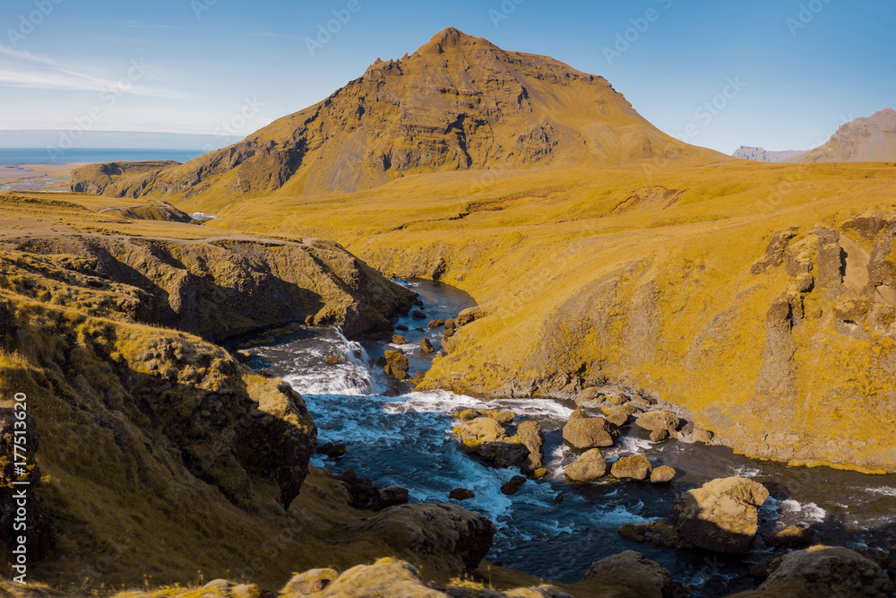 Iceland, mountain river, rock in the background