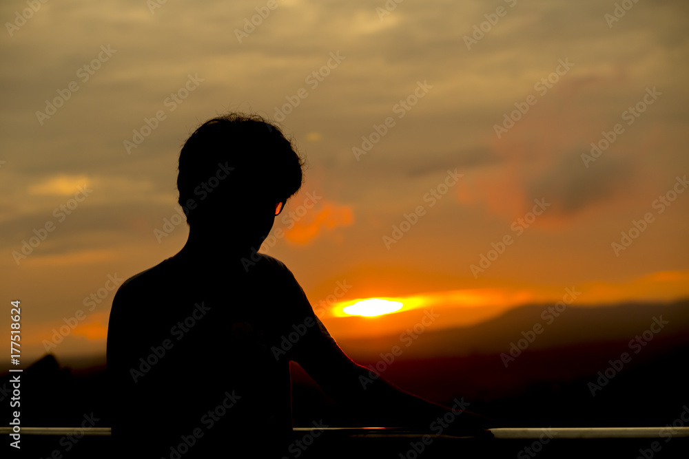 A man standing on a mountain The sun is falling. A man standing on a mountain The sun is falling.