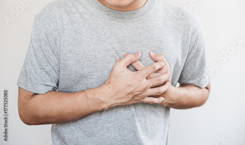 Принти на полотні a man touching his heart, heart attack and others heart disease concept, on whit
