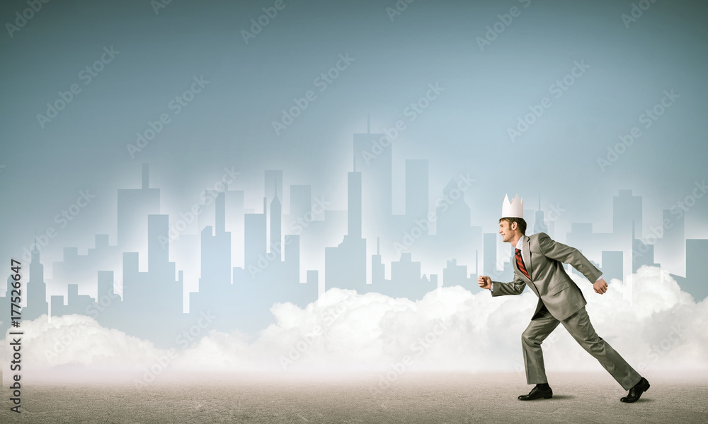 King businessman in elegant suit running and blue cityscape silh King businessman in elegant suit running and blue cityscape silh