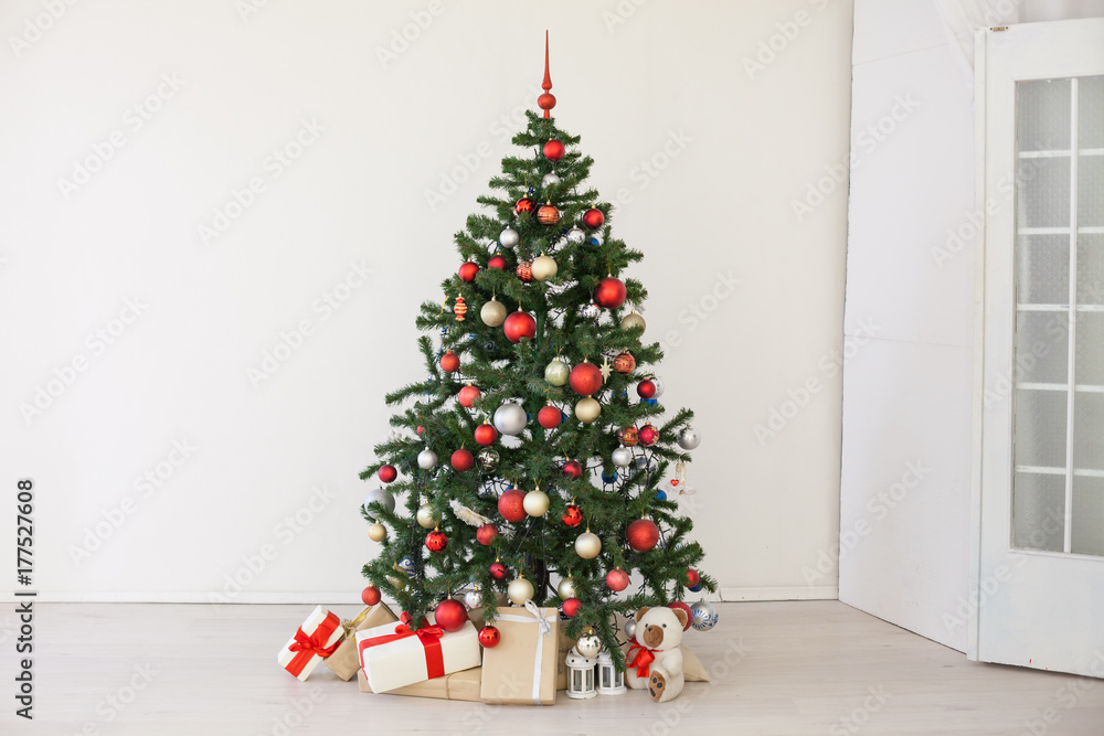 Christmas tree with red gifts in the white room Christmas Christmas tree with red gifts in the white room Christmas