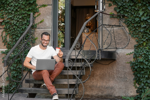 Handsome man with laptop si...