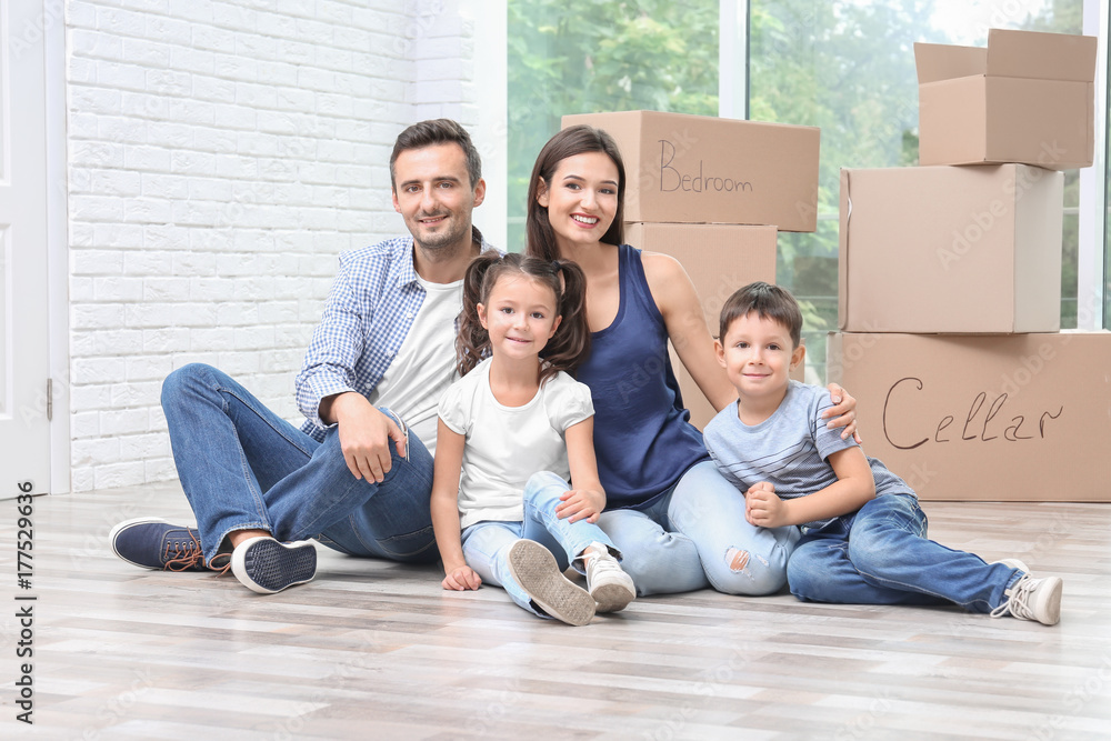 Happy family sitting on floor at new home Happy family sitting on floor at new home