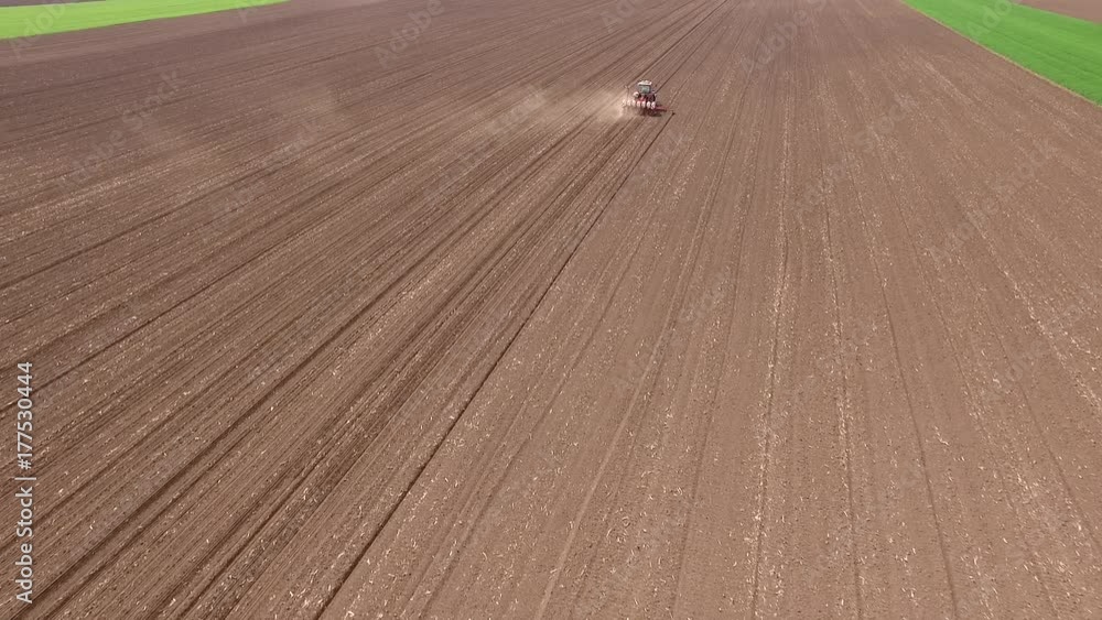 Aerial shot of a farmer seeding, sowing crops at field. Aerial shot of a farmer seeding, sowing crops at field.