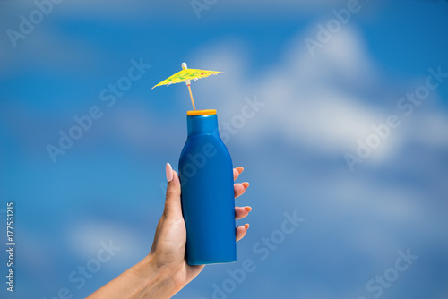 Sunscreen cream bottle on the beach
