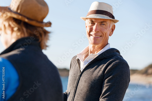Fotografie Senior man fishing with his grandson to fish at sea