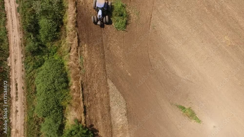 Aerial view of tractor cultivating wheat stubble field Aerial view of tractor cultivating wheat stubble field