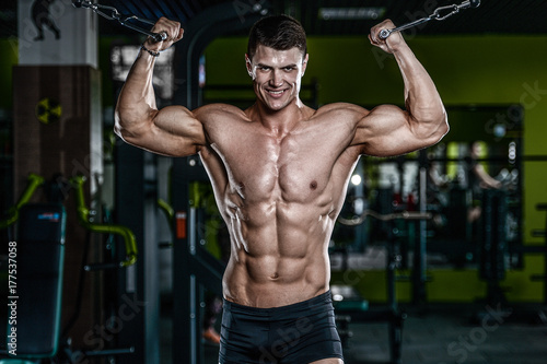 Attractive model young man training in gym