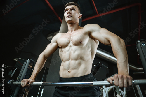 Handsome model young man working out in gym