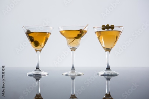 Cocktail with olives on table