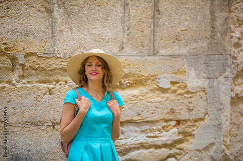 Traveling woman on stone old background, copy space © Елена Кравчук