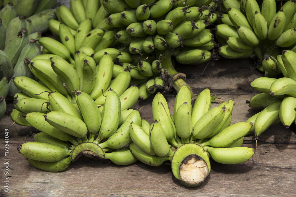 Raw Pisang Mas Banana Important economic crops of Thailand on wood stall in the market.