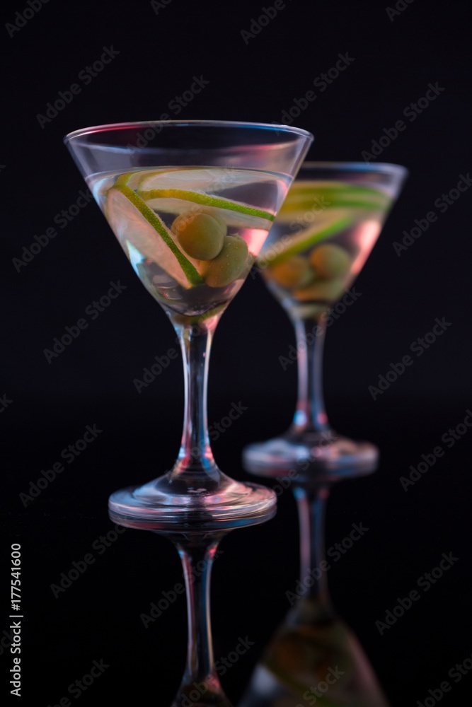 Cocktail martini with olives and lime on table Cocktail martini with olives and lime on table