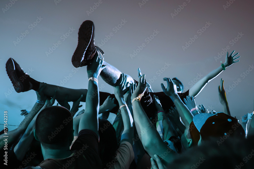 Stage diving. Crowd surfing during a musical performance