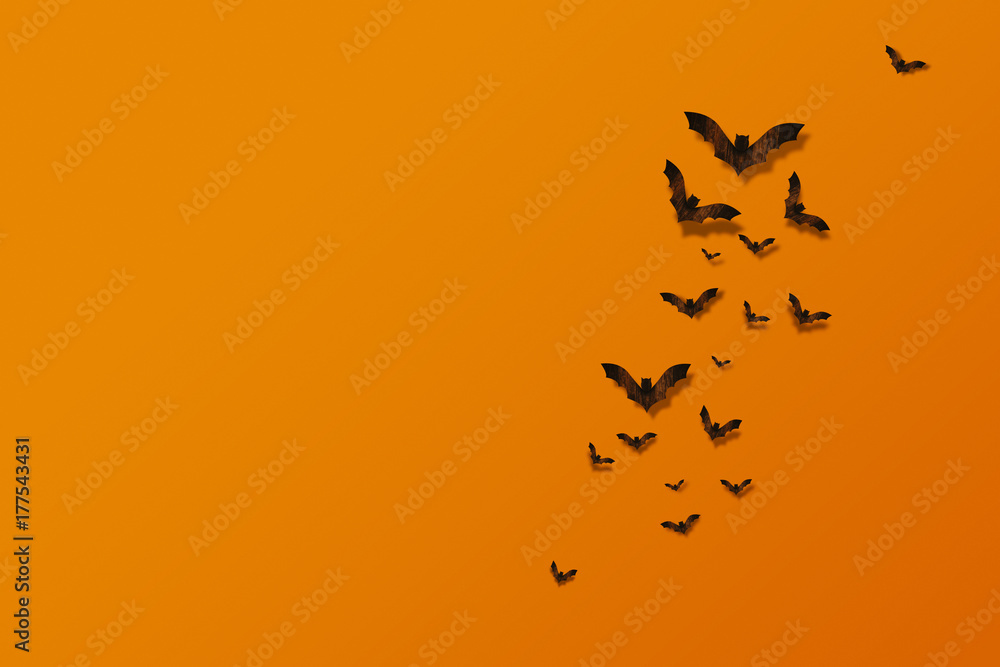 Halloween and decoration concept. Bats flying made from wood on orange brick wall Halloween and decoration concept. Bats flying made from wood on orange brick wall
