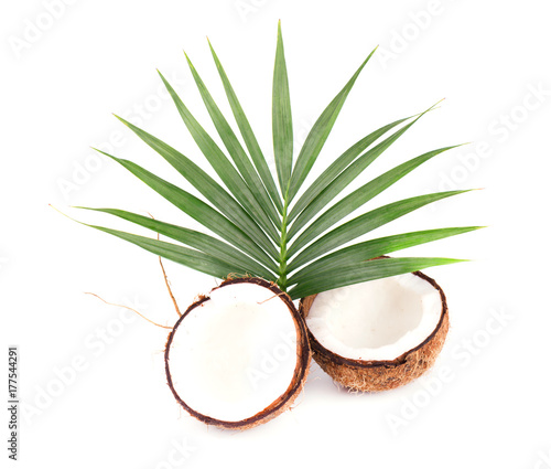 Coconut with half and leaves on white background. Close-up