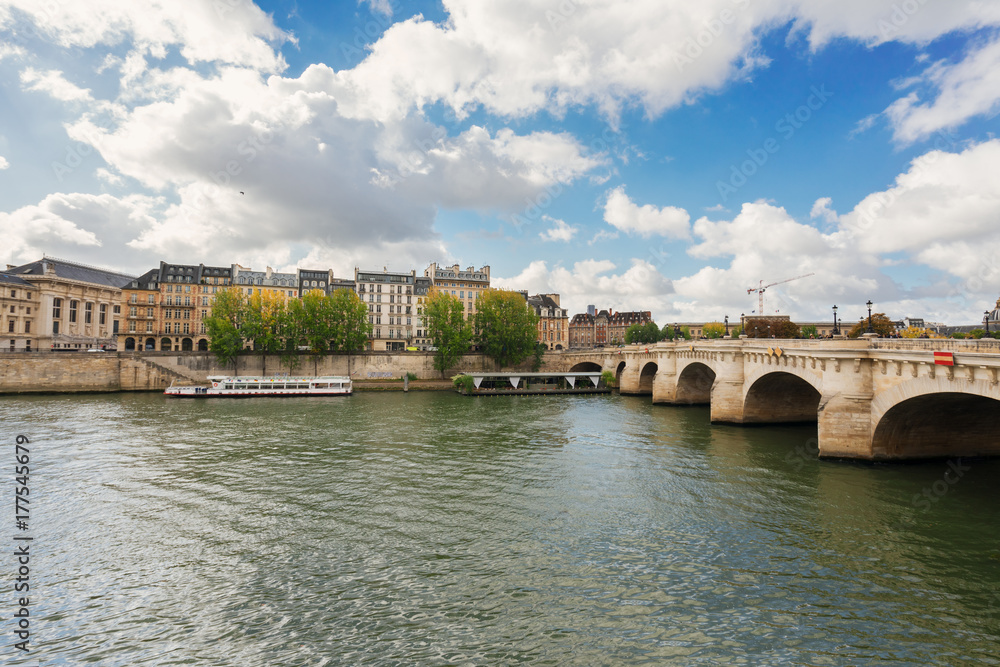 Fototapeta premium Pont Neuf and river Seine waters, blue sky with clouds, Paris, France, retro toned