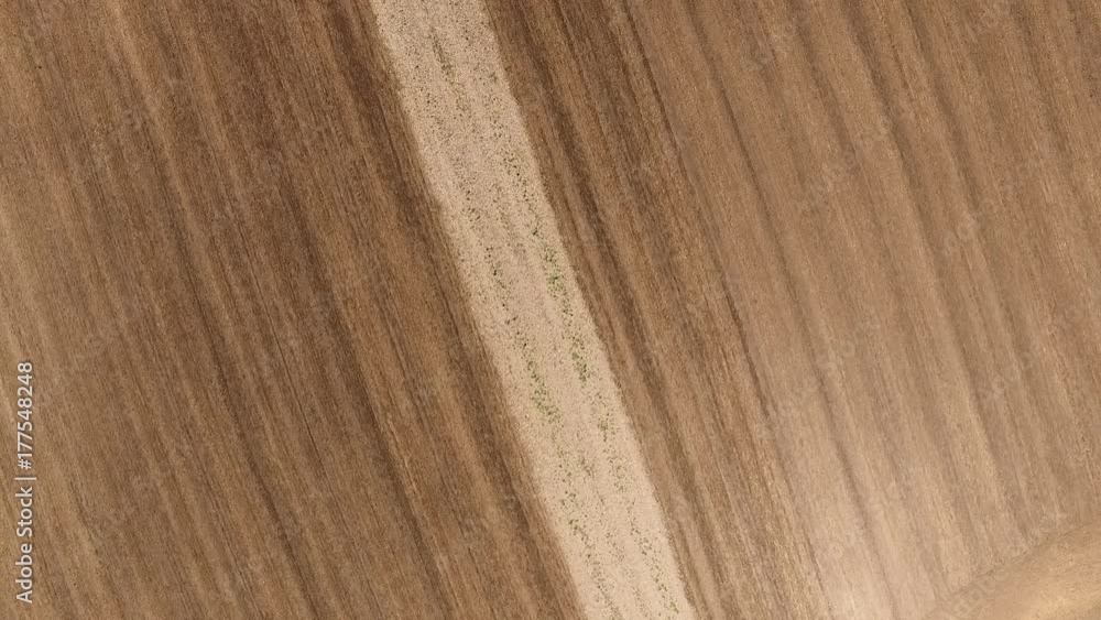 Aerial view of tractor cultivating wheat stubble field Aerial view of tractor cultivating wheat stubble field