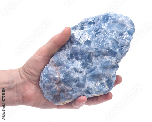 Fotografia Woman's hand holding raw blue calcite cluster isolated on white background
