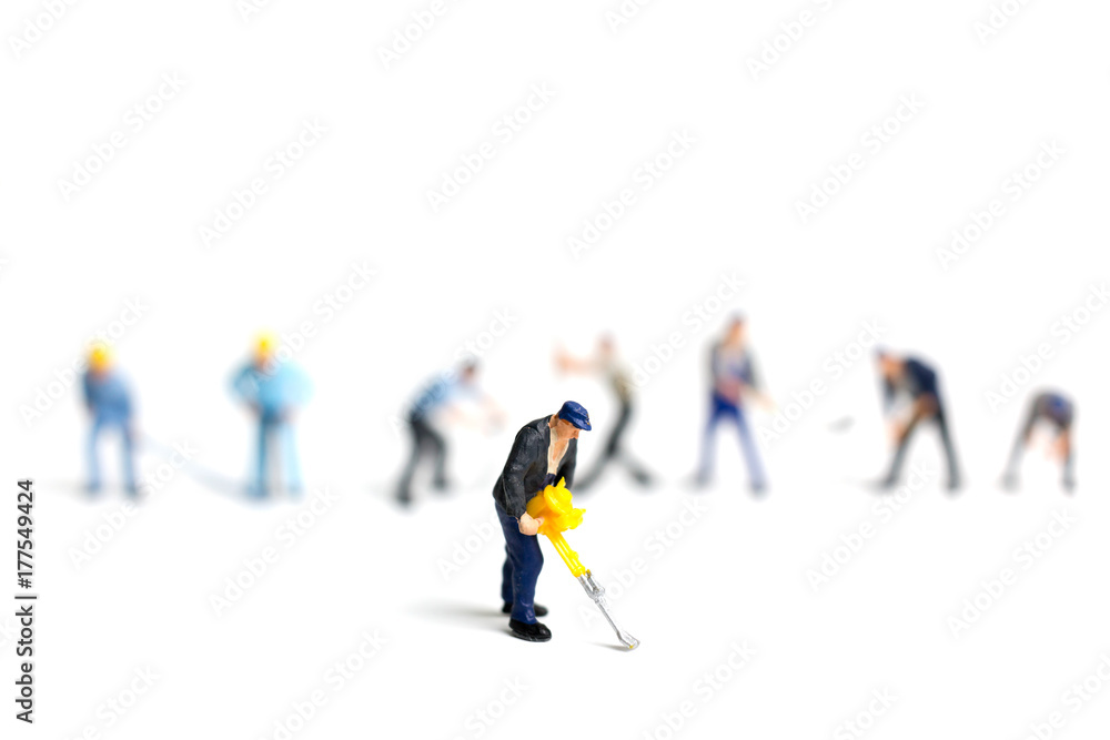Miniature people worker holding tool on white background, construction concept Miniature people worker holding tool on white background, construction concept