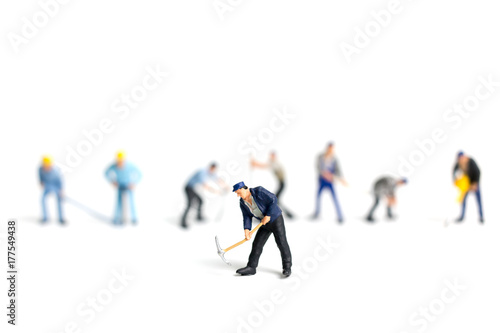 Miniature people worker holding tool on white background, construction concept