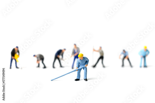 Miniature people worker holding tool on white background, construction concept