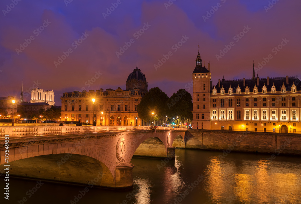 Pont au Change bridge and La Conciergerie - ex royal palace and prison at night, Paris, France
