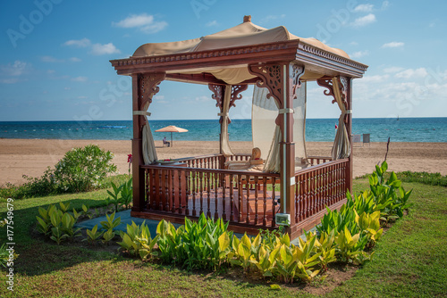 Fototapeta Naklejka Na Ścianę i Meble -  A cozy wooden sea bower on the beach.