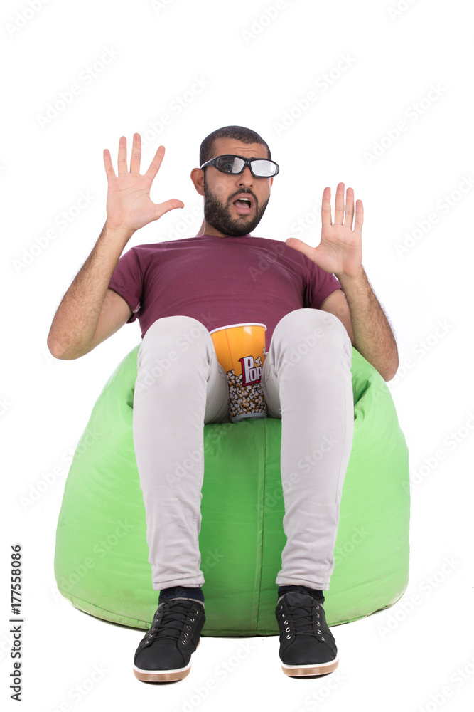 handsome young man wearing sunglasses sitting with bottles of red