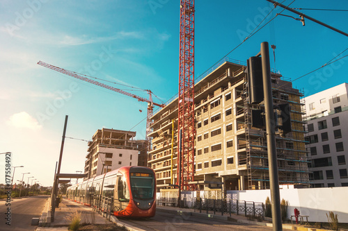 tram on railway in the city against sky 